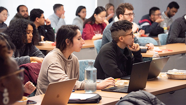 Student and staff sit in a classroom.